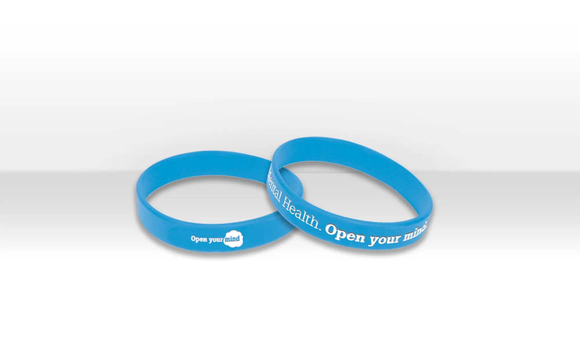Bright blue merchandise wristbands with motivational text promoting mental health awareness.