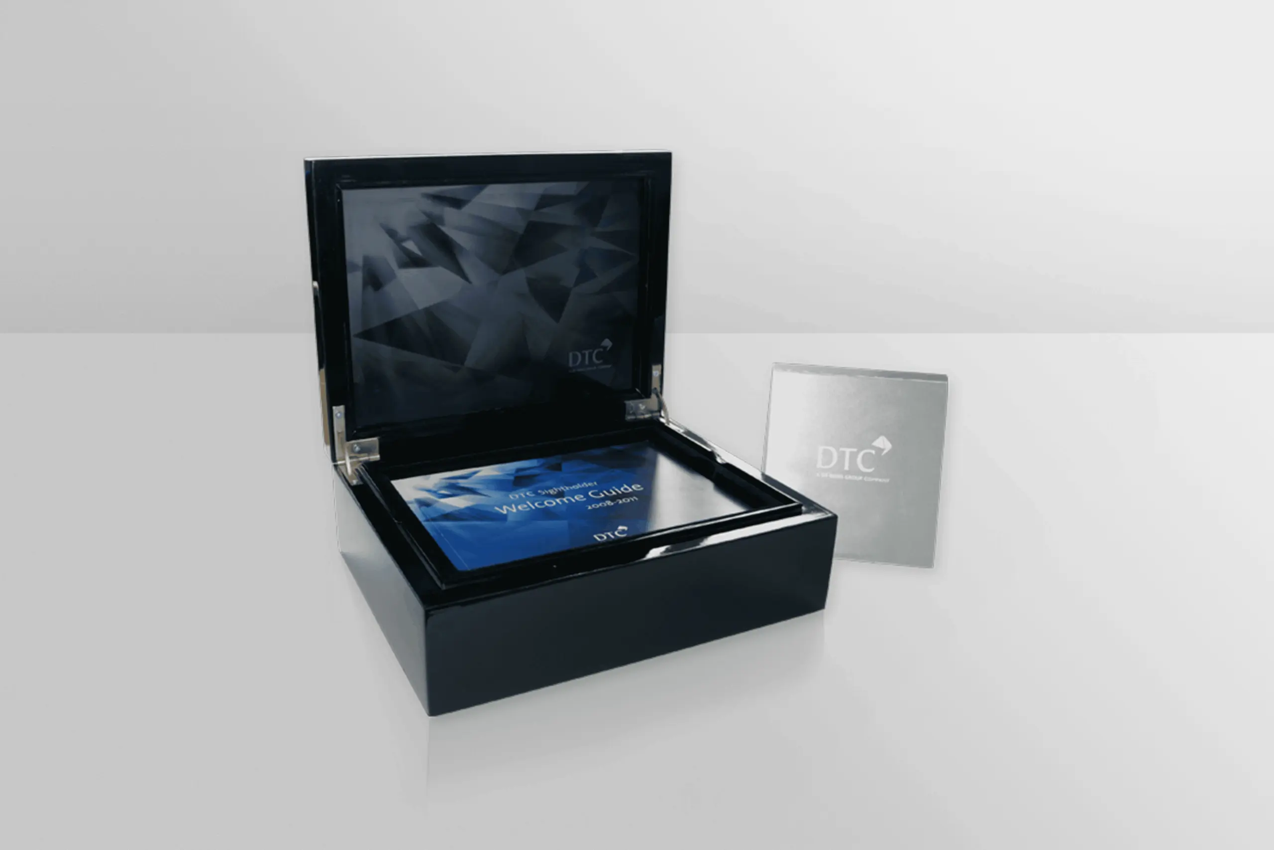WarmRed Creative showcases an elegant black box with a luxurious blue and gray interior design display for DeBeers