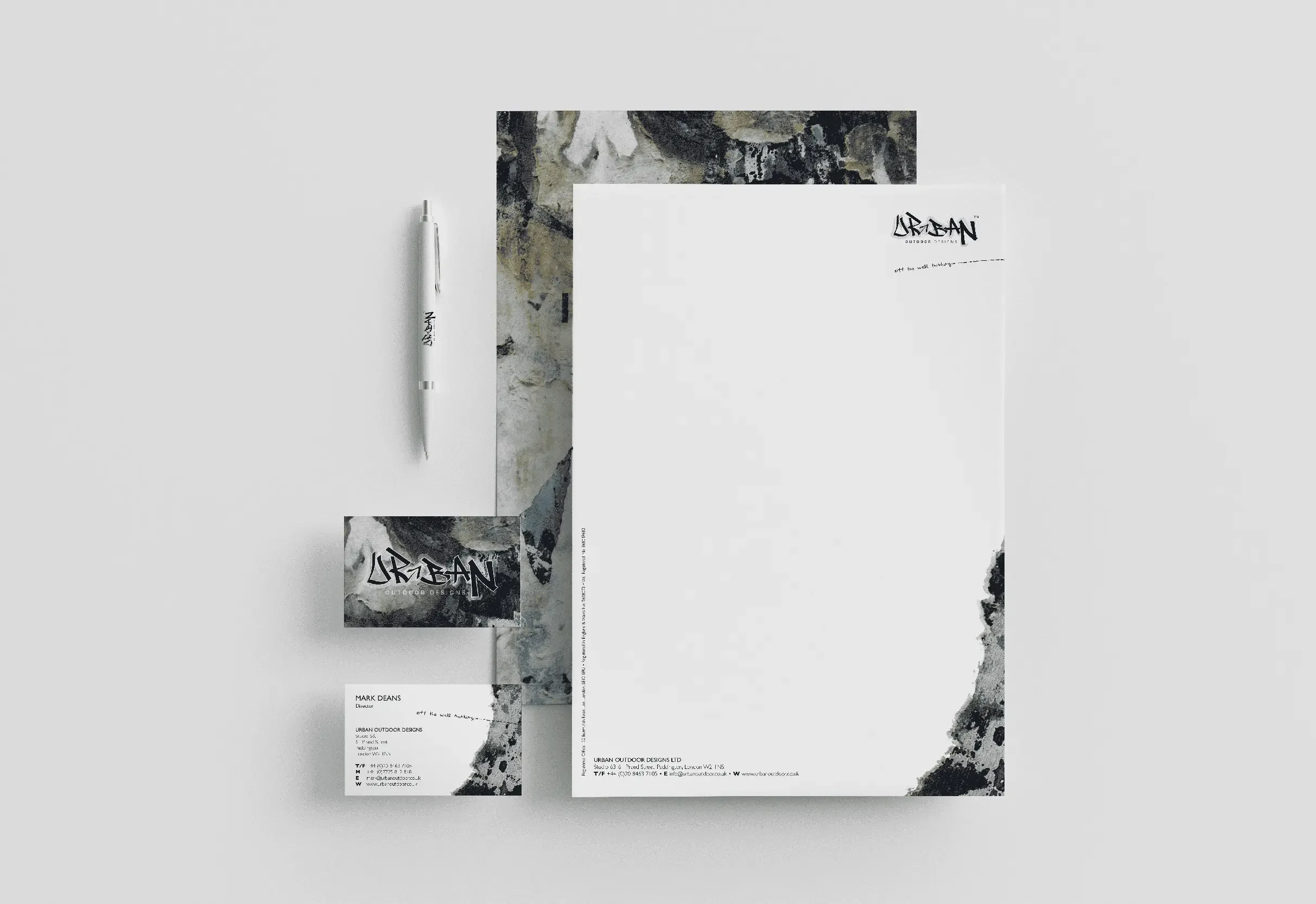 Elegant stationery set featuring pen letterhead and business cards in monochrome design for a company called UrbanOutdoor Designs