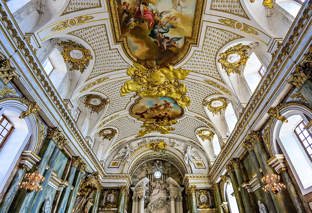 WarmRed Creative showcases an opulent baroque church interior with ornate gold detailing intricate frescoes and stunning architectural design capturing timeless elegance.